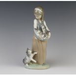 A Lladro figure of a girl holding kittens with a cat at her feet 25cm