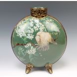 A Doulton Lambeth Faience moonflask, the green ground with a bird amongst flowers on scroll feet,