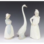 A Nao figure of a goose 33cm, a do. of a girl in a night dress 29cm and 1 of a girl holding a