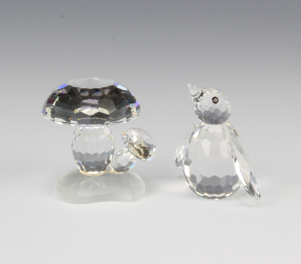 A Swarovski Crystal Toadstools by Adi Stocker 119206/7472030000 1989, 3cm together with a penguin by