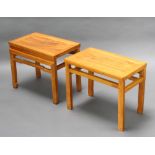 A pair of Chinese light Padauk rectangular stools/occasional tables raised on tapered supports