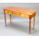 A Victorian stye rectangular mahogany side table fitted 3 long drawers raised on turned supports