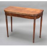 A Georgian mahogany D shaped folding tea table raised on turned supports 73cm h x 91cm w x 45cm d