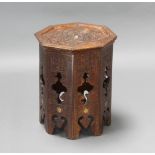 A Moorish octagonal carved hardwood table raised on pierced panelled supports 40cm h x 37cm w x 38cm