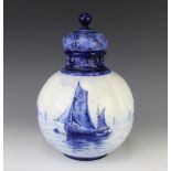 A Royal Worcester blue and white bulbous vase decorated with moored boats, the lid with flowers,