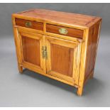 A Chinese light padauk cabinet fitted 2 drawers above double cupboard 68cm h x 114cm w x 47cm d