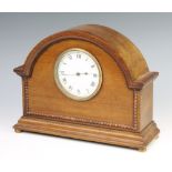 A 1930's French bedroom timepiece with enamelled dial and Roman numerals contained in an arched