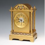 A 19th Century French 8 day striking mantel clock with gilt dial and Arabic numerals contained in