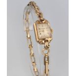 A lady's 9ct yellow gold Rotary wristwatch on a plated bracelet