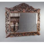 A Victorian rectangular bevelled plate wall mirror contained in a carved and pierced oak frame 109cm