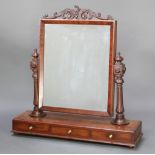 A Victorian rectangular plate dressing table mirror contained in a mahogany swing frame, the base