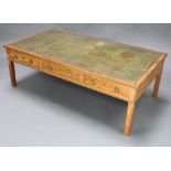 A 19th Century rectangular mahogany coffee table with inset green leather writing surface fitted 3