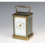 A 19th Century French 8 day carriage time piece with enamelled dial and Roman numerals contained