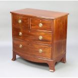 A Georgian style mahogany bow front chest of 2 short and 2 long drawers with brass ring drop