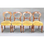 A set of Victorian carved mahogany hoop back dining chairs with carved mid rails and seats of