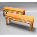A pair of rectangular Chinese light Padauk benches/stools raised on square tapered supports with