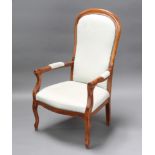 A Victorian style mahogany show frame open arm chair upholstered in light blue material, raised on