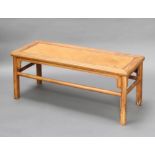 A Chinese rectangular light Padauk stool/coffee table with rattan panel to the centre 43cm h x 107cm