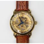 A Stuhrling gentleman's gilt wristwatch with visible movement on a leather strap, in original box