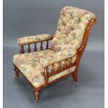 A Victorian mahogany show frame armchair with bobbin turned decoration upholstered in floral