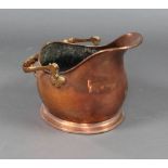 A copper helmet shaped coal scuttle with brass swing handle (some dents)
