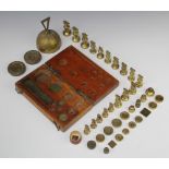 A collection of brass weights comprising two circular 4 oz, seven 1/2 oz weights, four circular 1/