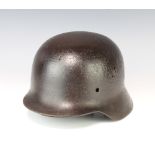 A German steel helmet The liner is missing and there are some rust and holes