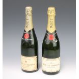 A bottle of Moet & Chandon Premier Cuvee champagne and 1 other labelled Brut Imperial