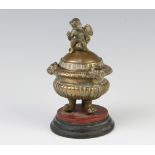 A Regency gilt metal inkwell in the form of a classical urn, the finial in the form of a seated