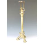 A Victorian brass adjustable table lamp raised on a Corinthian capital column with triform base
