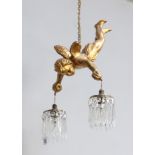 A gilt metal light fitting in the form of a flying cherub holding 2 circular drop lustres approx.
