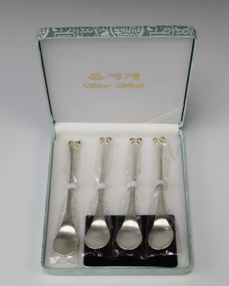A set of 4 800 standard spoons with enamelled ends