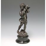 A Victorian style bronze figure of a standing cherub violinist raised on an ebonised socle base 35cm