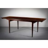 A ROSEWOOD EXTENDING DINING TABLE, DANISH, 1960s, of rectangular form, on tapering legs,220cm (l)