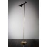 A TALL UPRIGHT FLOOR LIGHT, ITALIAN, 1960s, the adjustable tapering shade on a tubular brass