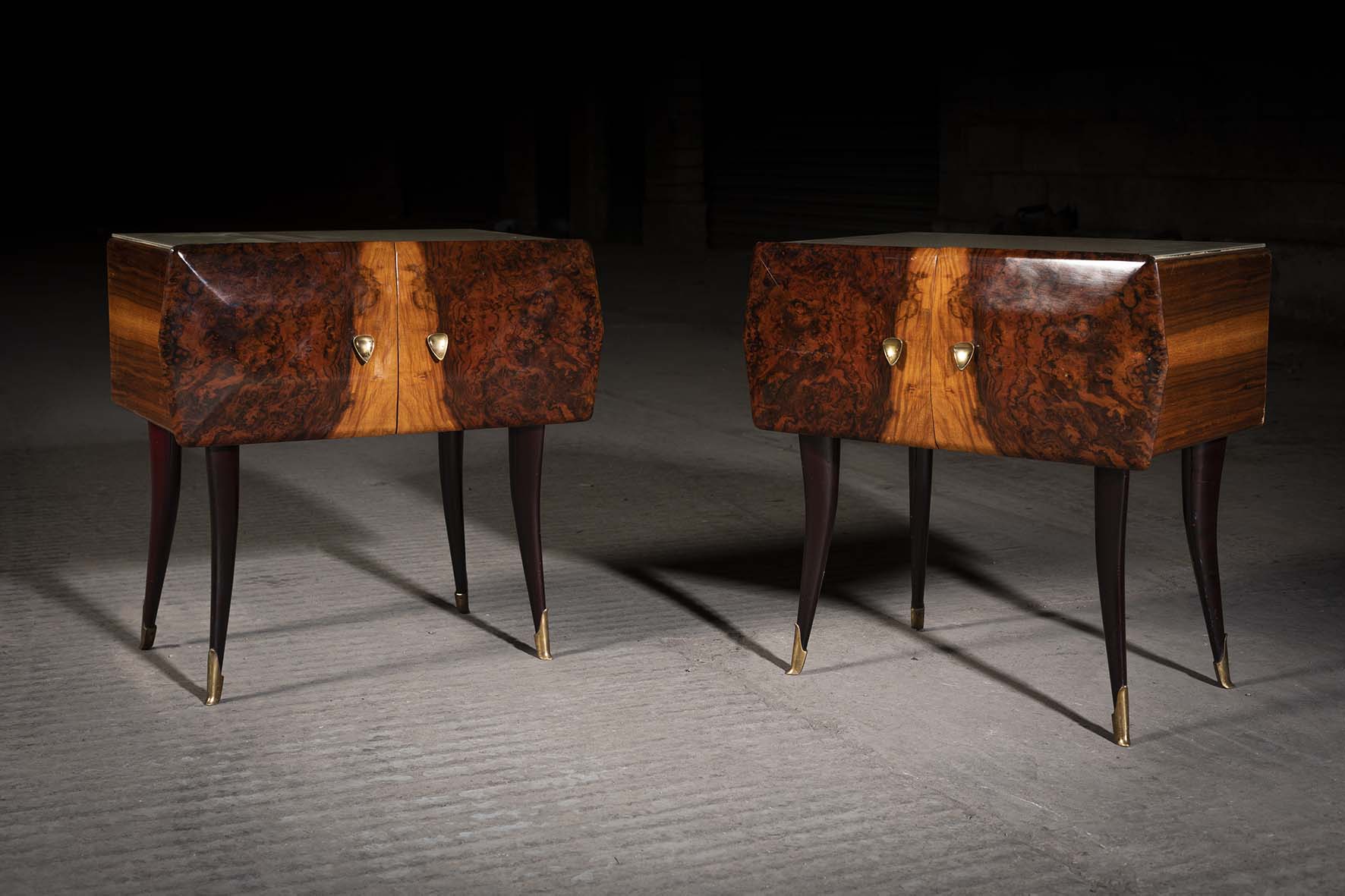 A PAIR OF WALNUT TWO DOOR BEDSIDE CABINETS, ITALIAN, 1960s, on tapering legs with gilt metal feet,