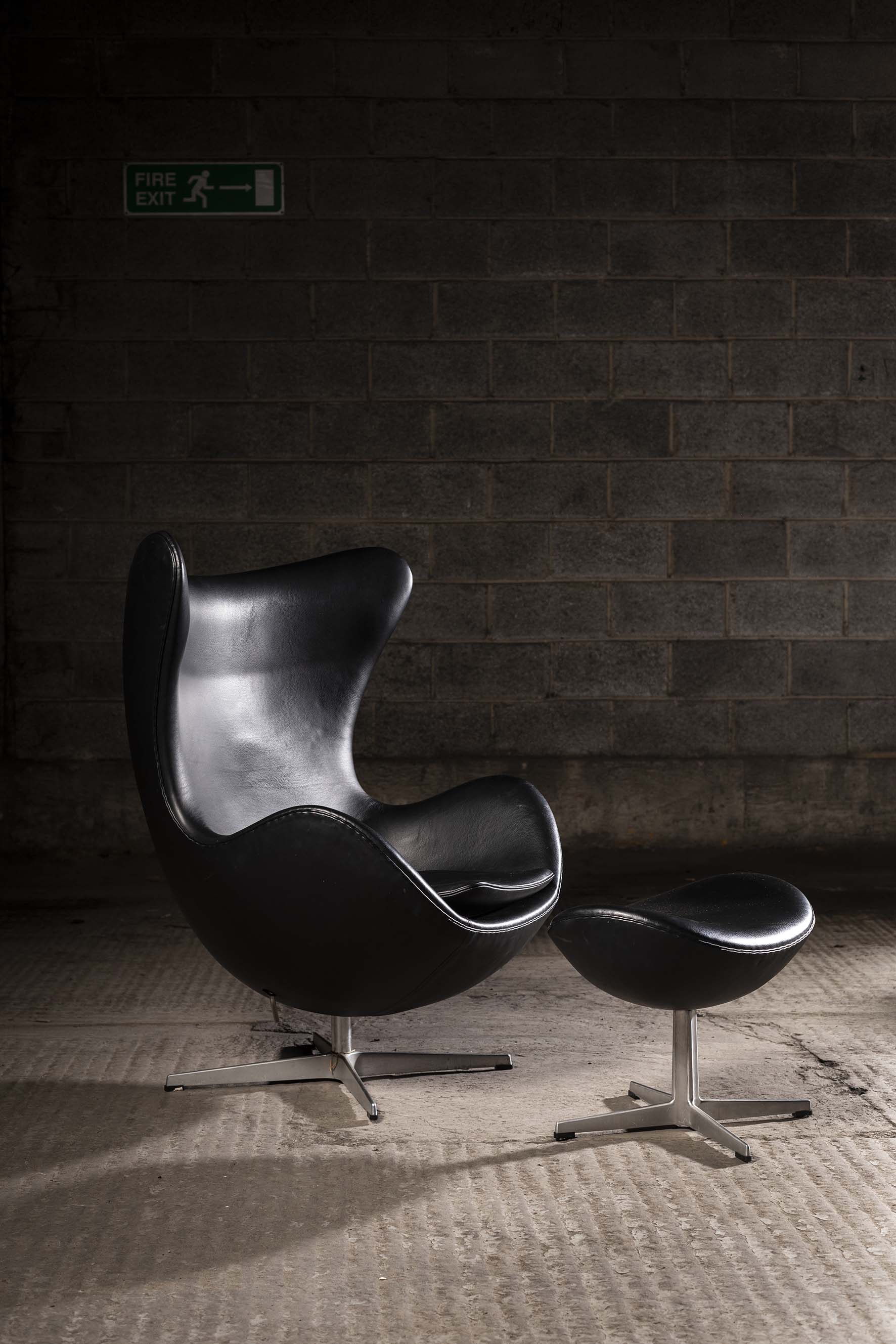 THE EGG CHAIR AND OTTOMAN, BY ARNE JACOBSEN FOR FRITZ HANSEN, EDITION 2008, in hand stitched black