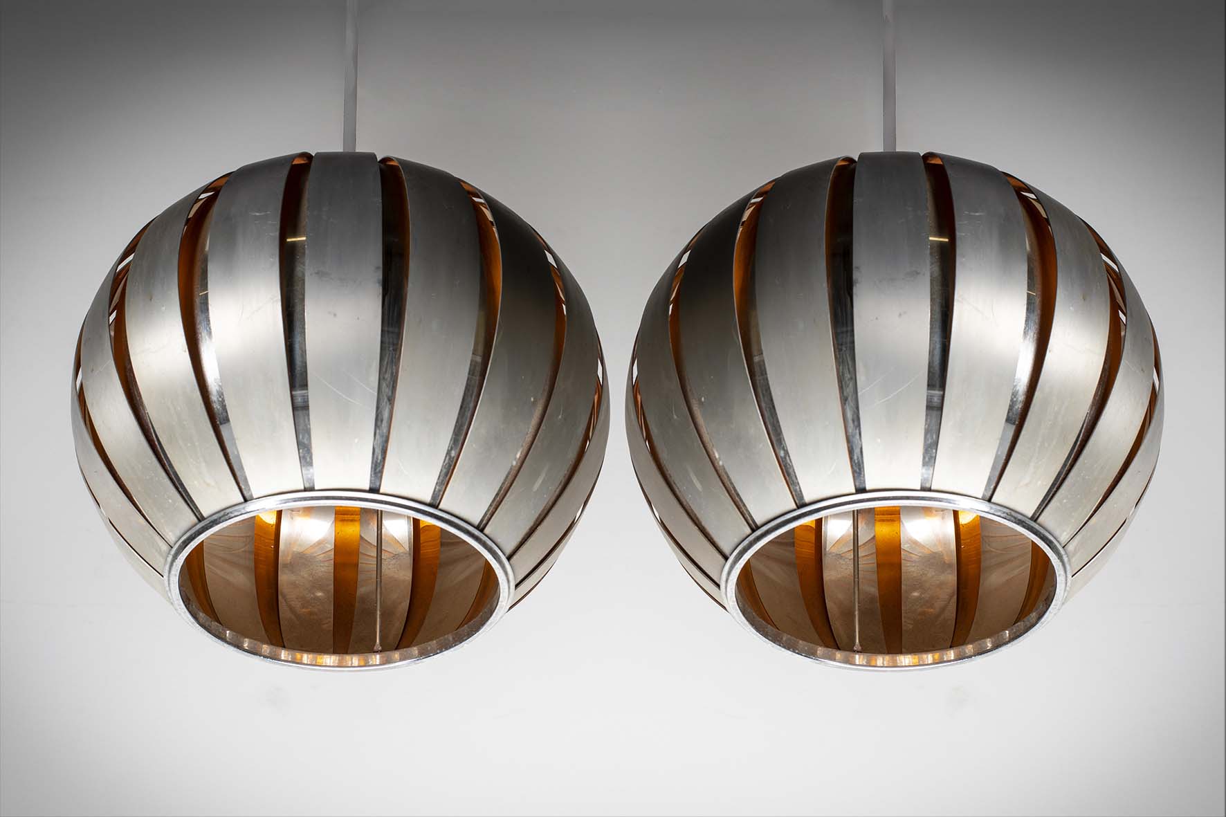 A PAIR OF METAL PENDANT LIGHTS,  IN THE MANNER OF LOUIS WEISDORFF, 90cm high x 40cm (diam)