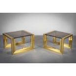 A PAIR OF GILT SIDE TABLES, ITALIAN, 1960'S with smoked glass tops, on angular bases. 60 cm (w) 50