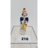 A 19TH CENTURY MOULDED STAFFORDSHIRE POTTERY CANDLE SNUFFER/FIGURE in the form of Mr Punch,