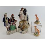 A 19TH CENTURY STAFFORDSHIRE POTTERY FIGURE entitled "Uncle Tom seated with Eva on his knee",