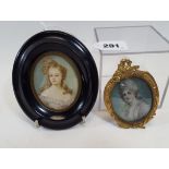 A 19TH/20TH CENTURY OVAL HAND PAINTED MINIATURE OF A YOUNG LADY in a gilt brass frame,