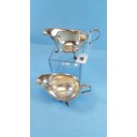 A PAIR OF GEORGE V SILVER SAUCE BOATS with shaped rims raised on cabriole legs, maker:- J.D.