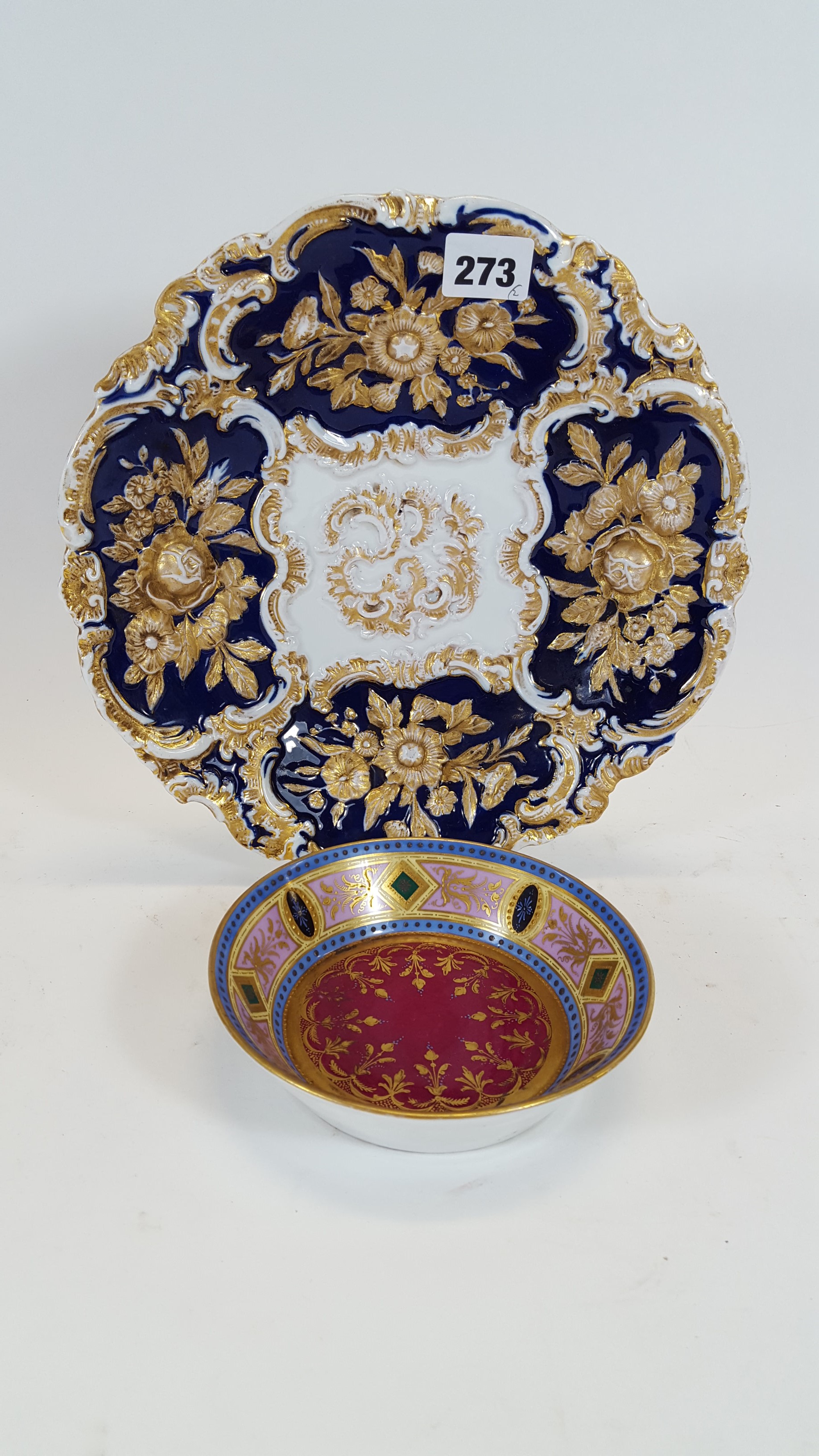 A LATE 19TH CENTURY MEISSEN BLUE/WHITE GROUND PORCELAIN PLATE with moulded floral gilt decoration,