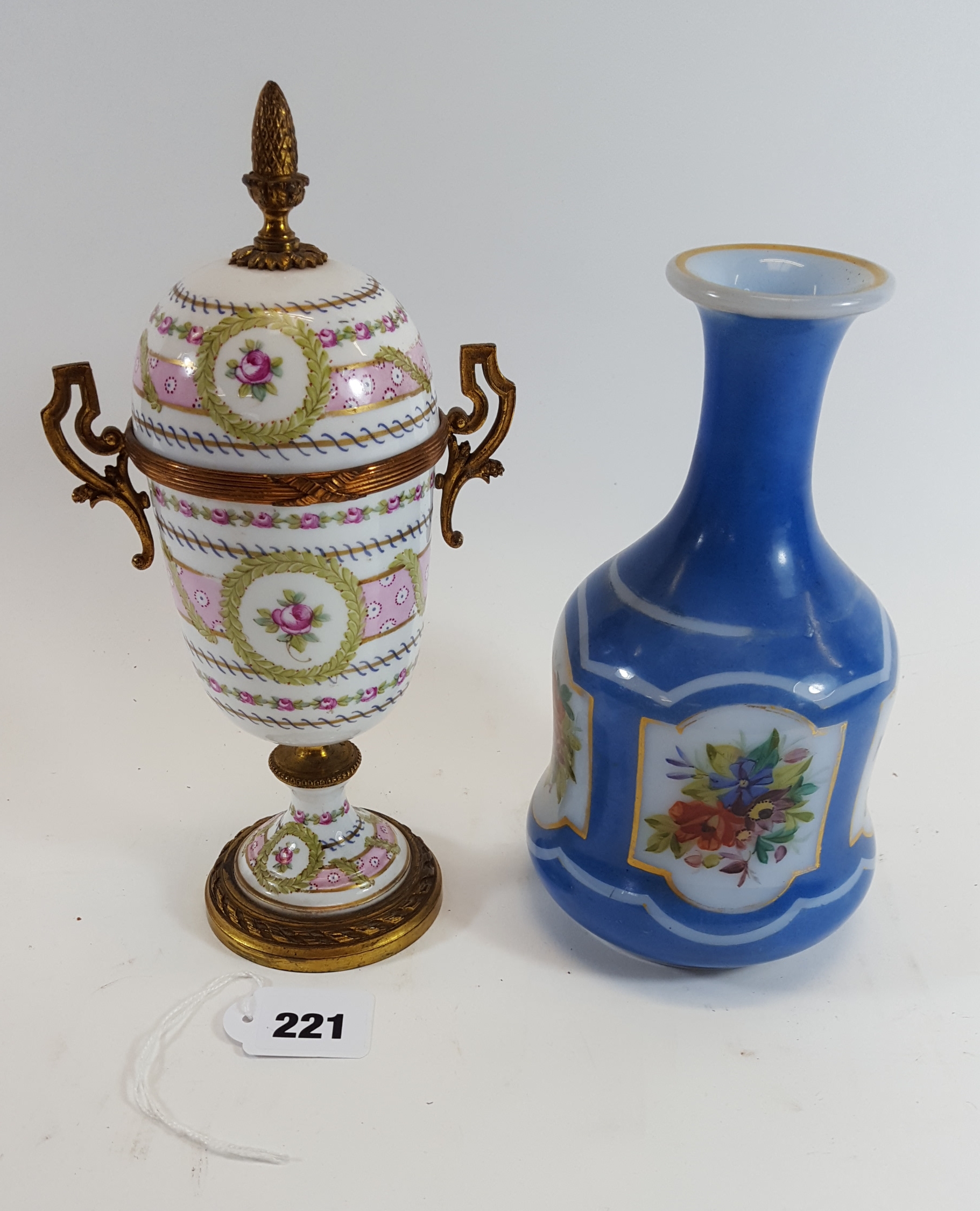 AN EARLY 20TH CENTURY FRENCH PORCELAIN ORMOLU MOUNTED VASE AND COVER decorated with garlands of