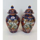 A PAIR OF LATE 19TH CENTURY JAPANESE IMARI PORCELAIN VASES AND COVER decorated with panels of long