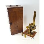 BAKER, 244 HIGH HOLBORN, LONDON, A LACQUERED BRASS MICROSCOPE, two spare lenses,