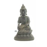 AN 18TH CENTURY CHINESE BRONZE FIGURE OF A SEATED BUDDHA on integral base, 10 1/2 ins high.