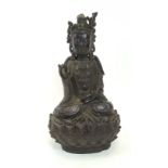 AN 18TH CENTURY CHINESE BRONZE FIGURE OF A SEATED BUDDHA on an integral lotus leaf base,