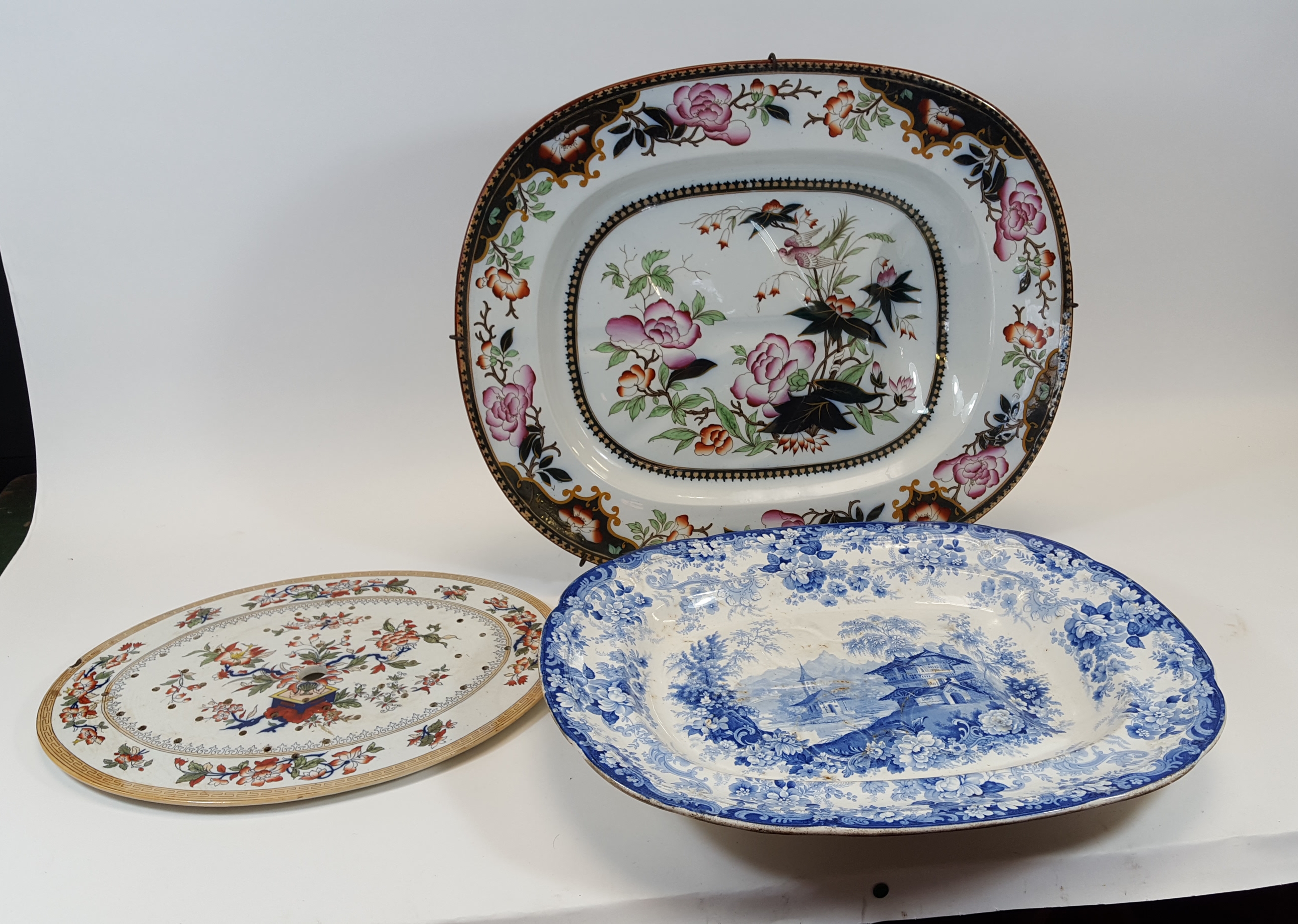 A 19TH CENTURY FLORAL AND BIRD DECORATED MEAT PLATE with tree and well indents, 17 1/2 ins x 21 ins,